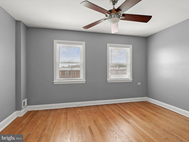 empty room with light wood-style floors, baseboards, and a ceiling fan