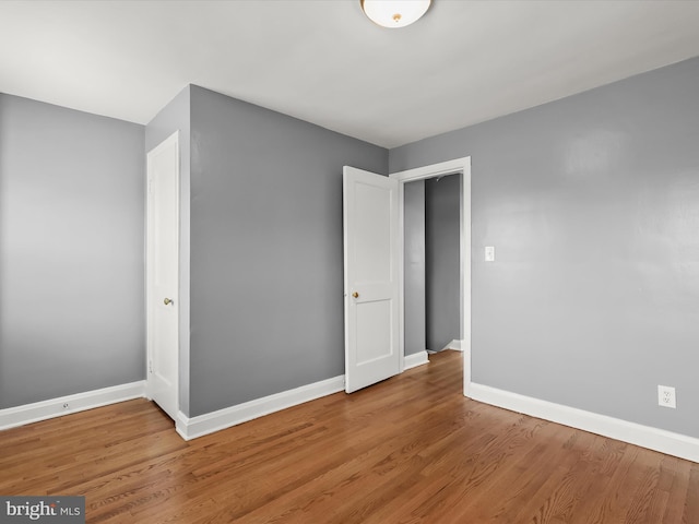 unfurnished bedroom featuring baseboards and light wood-style flooring