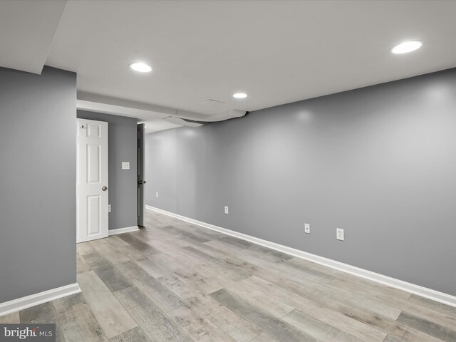 finished basement featuring recessed lighting, baseboards, and light wood-style floors