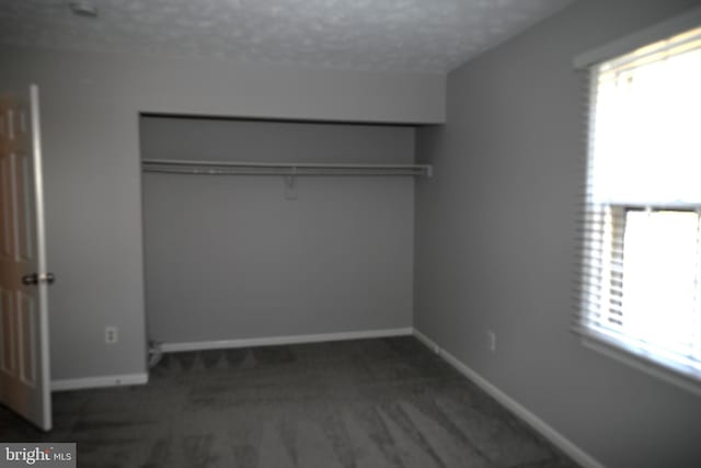 3539 Smokethorn Ct, Waldorf, MD 20602 - unfurnished bedroom with a closet, multiple windows, a textured ceiling, and baseboards