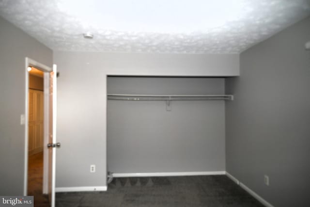 3539 Smokethorn Ct, Waldorf, MD 20602 - unfurnished bedroom with baseboards, a closet, and dark carpet