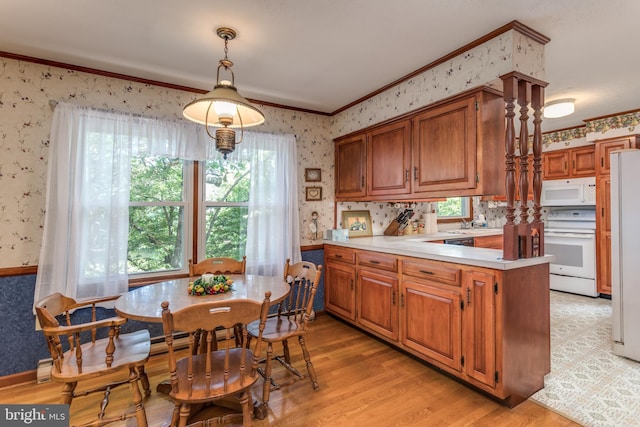 126 Armstrong Pl, Winchester, VA 22602 - kitchen with wallpapered walls, white appliances, a peninsula, brown cabinetry, and light countertops