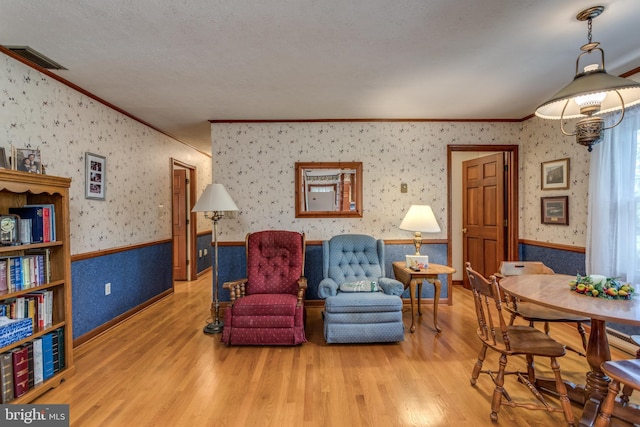 126 Armstrong Pl, Winchester, VA 22602 - living area with visible vents, wainscoting, wallpapered walls, and wood finished floors