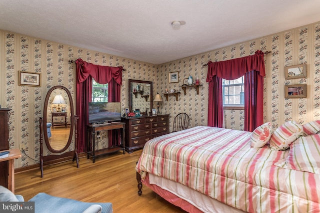 126 Armstrong Pl, Winchester, VA 22602 - bedroom featuring wallpapered walls, multiple windows, and wood finished floors