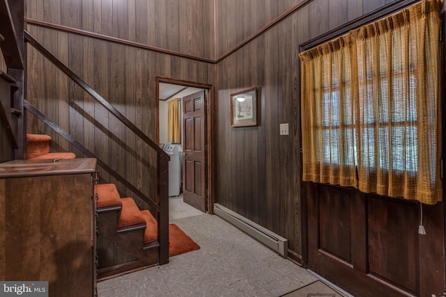 126 Armstrong Pl, Winchester, VA 22602 - entrance foyer with a baseboard radiator, washer / dryer, wood walls, and stairs