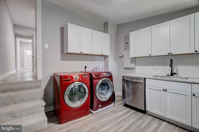 1843 W Pratt St, Baltimore, MD 21223 - washroom with light wood-style floors, washing machine and clothes dryer, and baseboards