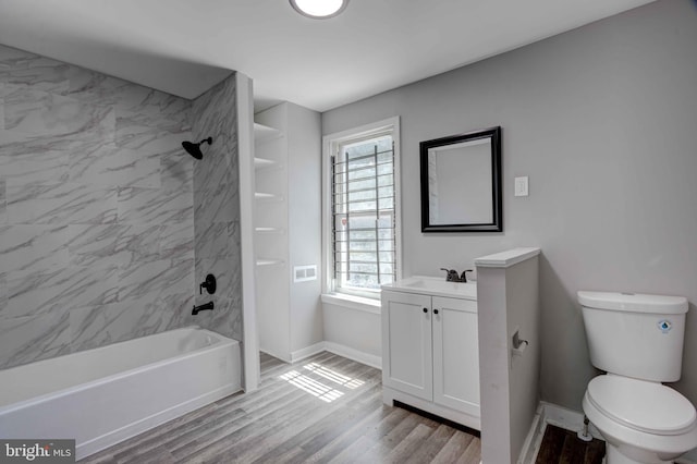 1843 W Pratt St, Baltimore, MD 21223 - full bath featuring toilet, baseboards, vanity, washtub / shower combination, and wood finished floors