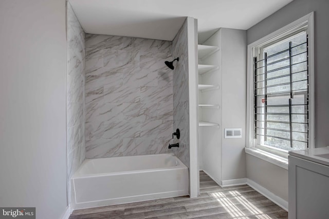 1843 W Pratt St, Baltimore, MD 21223 - full bath featuring bathtub / shower combination, wood finished floors, and baseboards