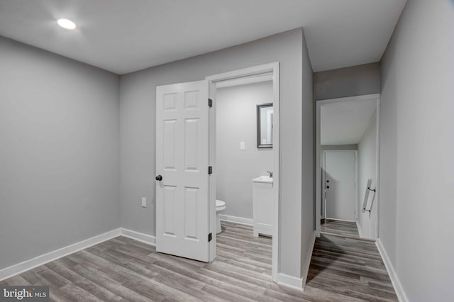1843 W Pratt St, Baltimore, MD 21223 - unfurnished bedroom with wood finished floors, baseboards, ensuite bathroom, and recessed lighting