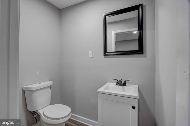 1843 W Pratt St, Baltimore, MD 21223 - bathroom with toilet, vanity, baseboards, and wood finished floors
