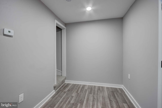 1843 W Pratt St, Baltimore, MD 21223 - empty room featuring wood finished floors, baseboards, and stairway