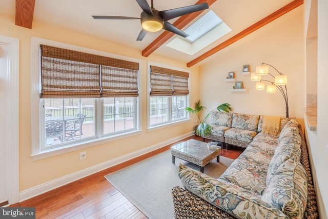 14926 Victory Ln, Glenelg, MD 21737 - living room featuring baseboards, vaulted ceiling with skylight, wood finished floors, and ceiling fan