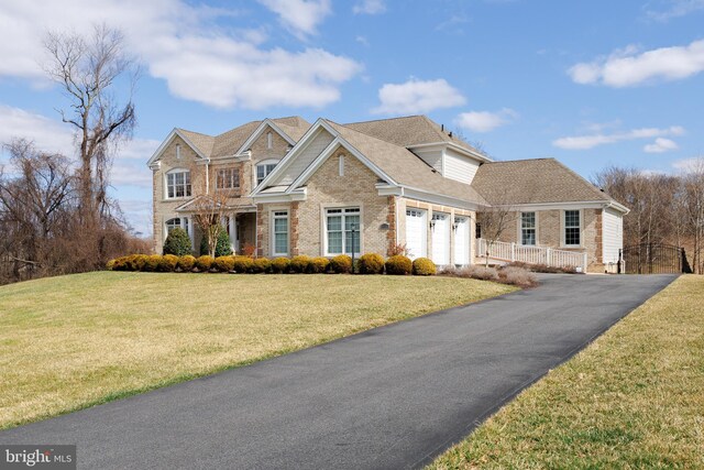 14926 Victory Ln, Glenelg, MD 21737 - view of front of property with a front lawn, an attached garage, brick siding, and aphalt driveway