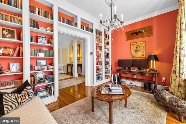 24 Whitfield Rd, Baltimore, MD 21210 - living area with baseboards, built in features, ornamental molding, wood finished floors, and a notable chandelier