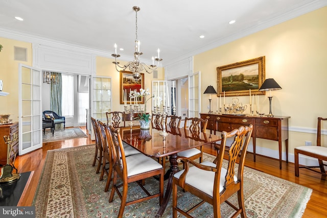 24 Whitfield Rd, Baltimore, MD 21210 - dining room with a notable chandelier, ornamental molding, wood finished floors, recessed lighting, and baseboards
