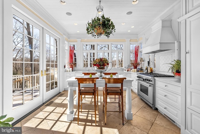 24 Whitfield Rd, Baltimore, MD 21210 - kitchen featuring custom exhaust hood, high end range, light countertops, and crown molding