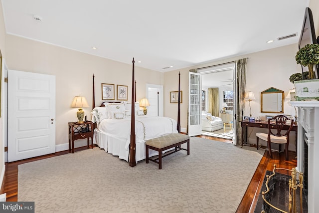 24 Whitfield Rd, Baltimore, MD 21210 - bedroom featuring visible vents, a fireplace with flush hearth, wood finished floors, recessed lighting, and baseboards