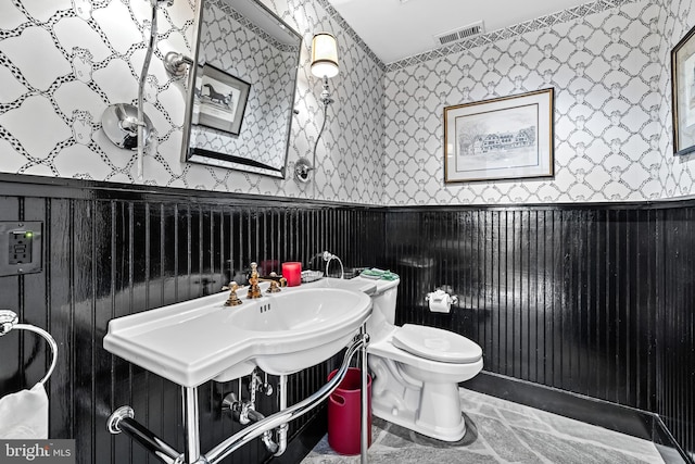 24 Whitfield Rd, Baltimore, MD 21210 - bathroom with a wainscoted wall, toilet, wallpapered walls, and visible vents
