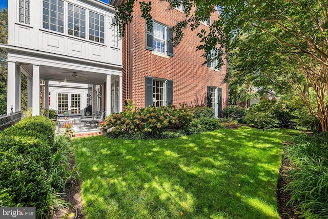 24 Whitfield Rd, Baltimore, MD 21210 - rear view of property with brick siding, a lawn, french doors, and a ceiling fan
