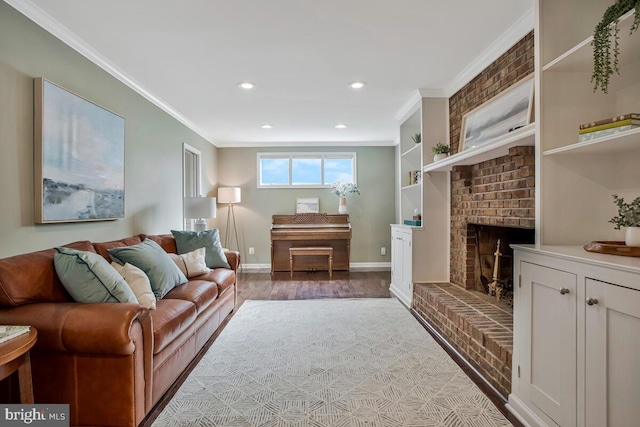 living area featuring ornamental molding, light wood-style flooring, recessed lighting, a brick fireplace, and baseboards