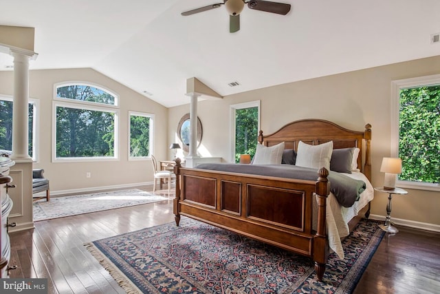 bedroom with lofted ceiling, ornate columns, dark wood-type flooring, baseboards, and ceiling fan