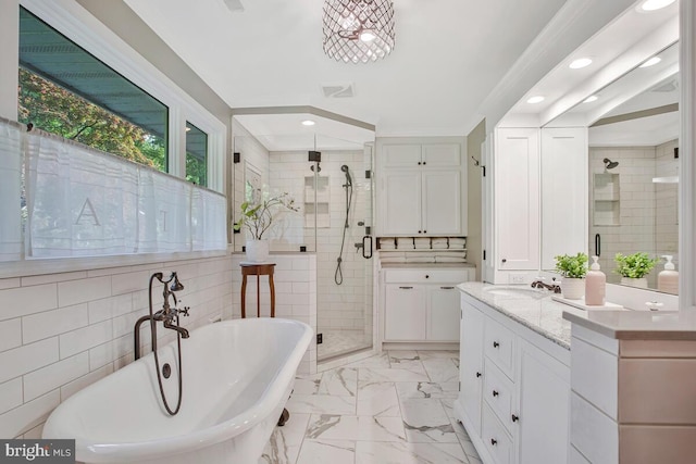 bathroom with a stall shower, recessed lighting, a freestanding bath, vanity, and marble finish floors