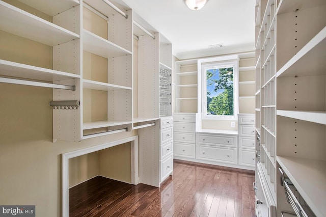 spacious closet with dark wood-style floors