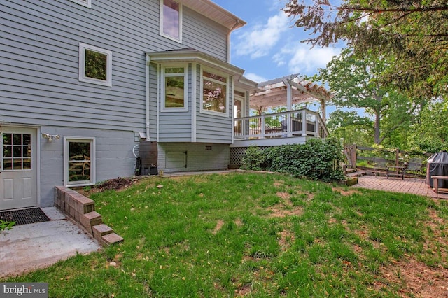view of grassy yard with a pergola and a wooden deck