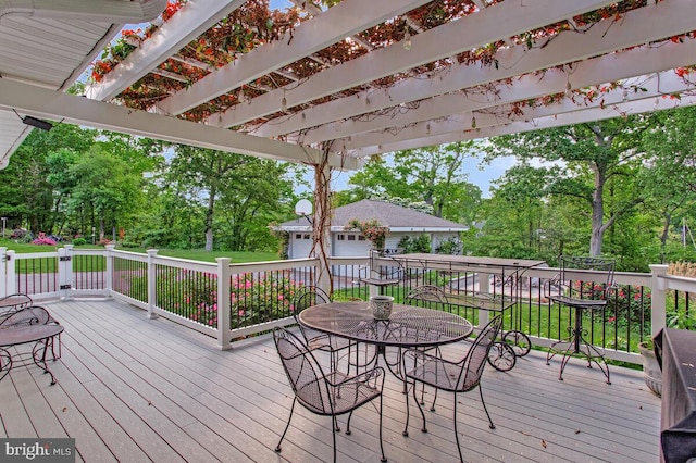 wooden deck with outdoor dining space, a pergola, view of scattered trees, and an outdoor structure