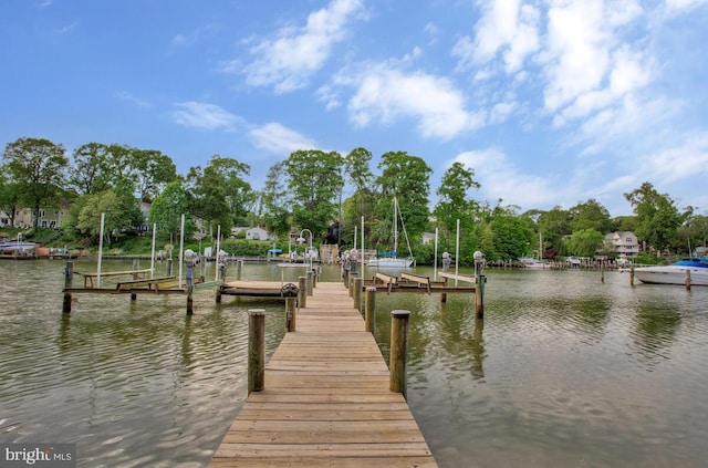dock area with boat lift and a water view
