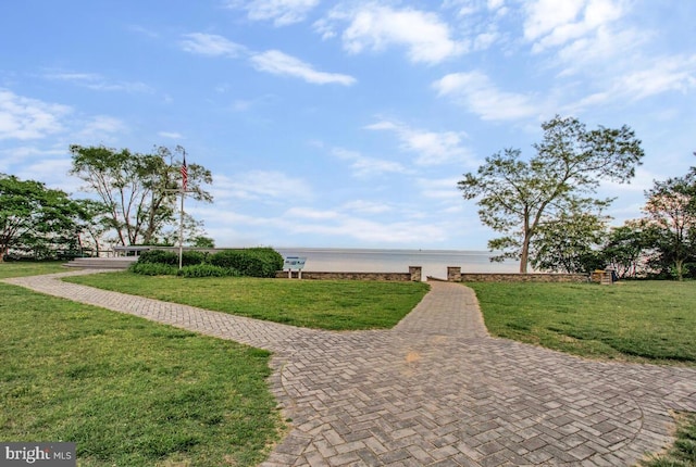 view of home's community featuring a water view and a yard