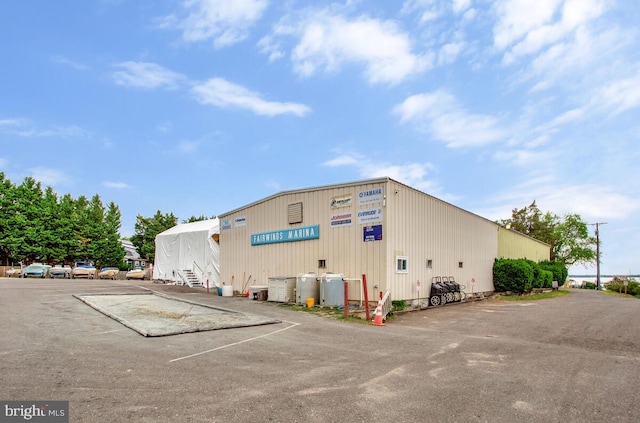 view of building exterior featuring uncovered parking
