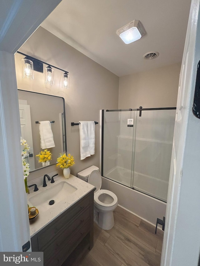 202 Moonlight Dr, Frostburg, MD 21532 - full bathroom featuring visible vents, toilet, wood finished floors, shower / bath combination with glass door, and vanity