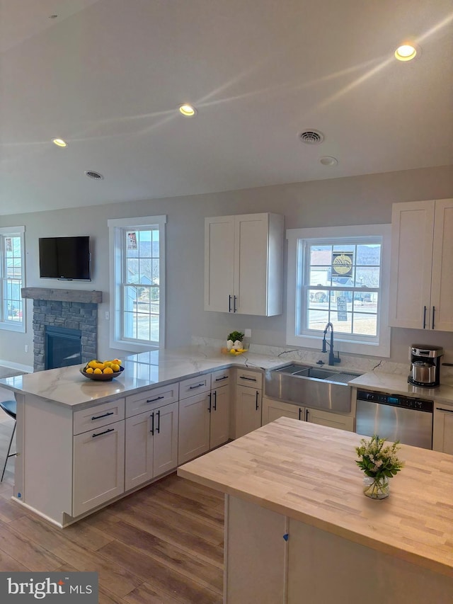 202 Moonlight Dr, Frostburg, MD 21532 - kitchen with a healthy amount of sunlight, white cabinetry, a peninsula, a sink, and dishwasher