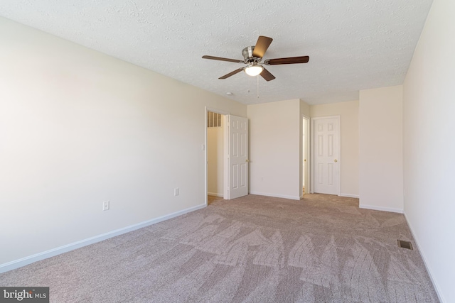 unfurnished bedroom with baseboards, visible vents, carpet, and a textured ceiling