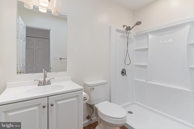 full bathroom featuring vanity, toilet, and a stall shower