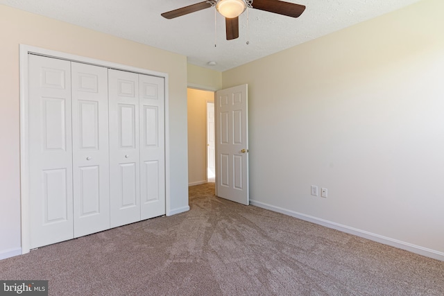 unfurnished bedroom featuring a ceiling fan, baseboards, carpet floors, and a closet