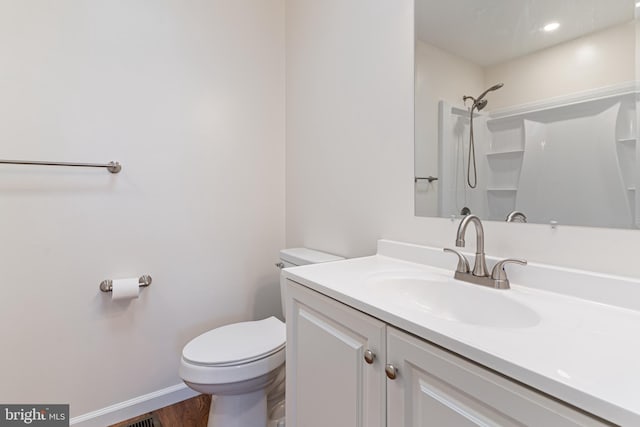 full bathroom with toilet, baseboards, wood finished floors, a shower, and vanity