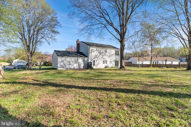 view of yard featuring fence and cooling unit