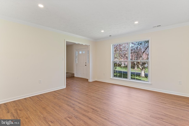 unfurnished room featuring light wood finished floors, baseboards, and recessed lighting