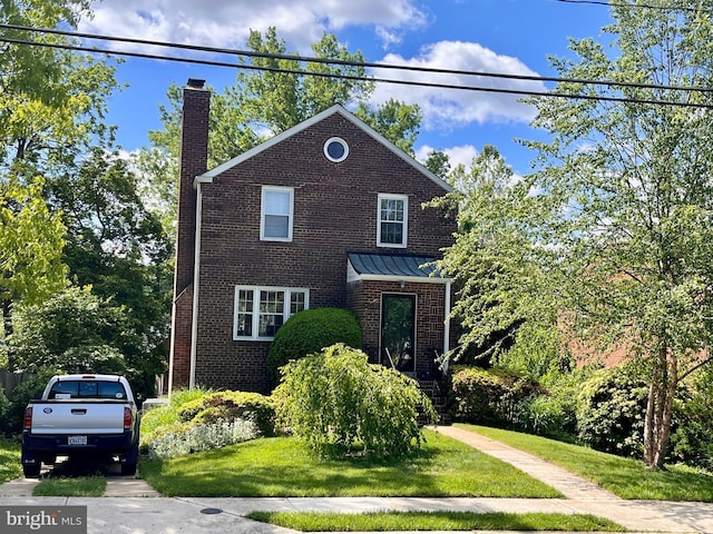 6012 19th St N, Arlington, VA 22205 - view of front of property featuring a chimney, brick siding, a front lawn, and a standing seam roof