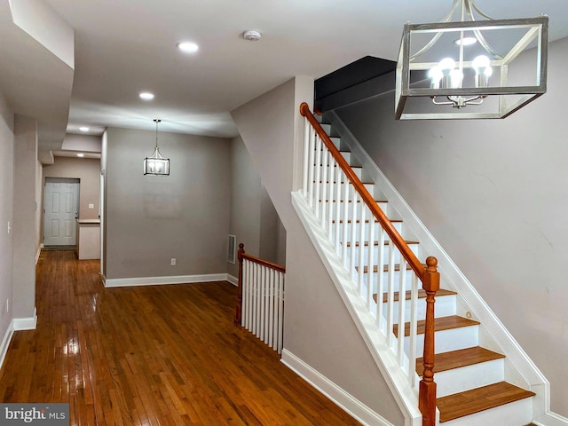 738 N Patterson Park Ave, Baltimore, MD 21205 - stairway featuring visible vents, hardwood / wood-style flooring, recessed lighting, an inviting chandelier, and baseboards
