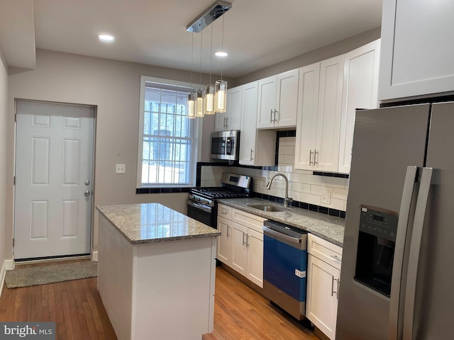 738 N Patterson Park Ave, Baltimore, MD 21205 - kitchen with a sink, a kitchen island, appliances with stainless steel finishes, and light wood-style flooring