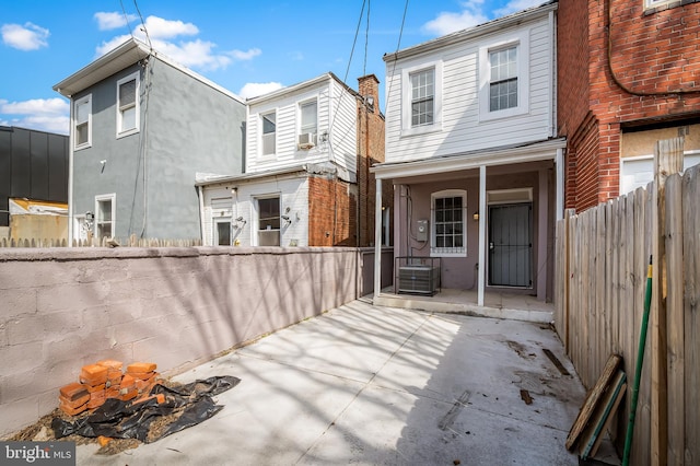 738 N Patterson Park Ave, Baltimore, MD 21205 - rear view of house featuring cooling unit, stucco siding, a porch, and fence