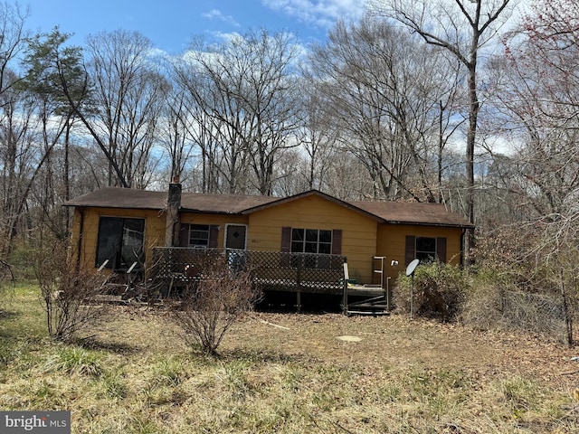 back of house with a deck