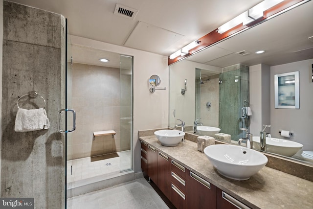 full bath featuring visible vents, a shower stall, and a sink