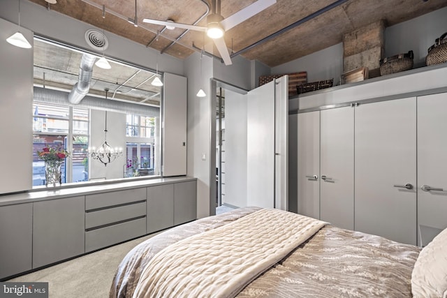 carpeted bedroom featuring a closet and an inviting chandelier