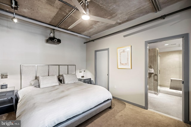 bedroom with ceiling fan, connected bathroom, carpet floors, and baseboards