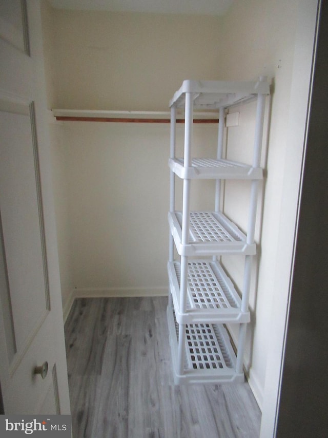 spacious closet with wood finished floors
