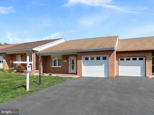 ranch-style home with aphalt driveway, a front lawn, brick siding, an attached garage, and a shingled roof